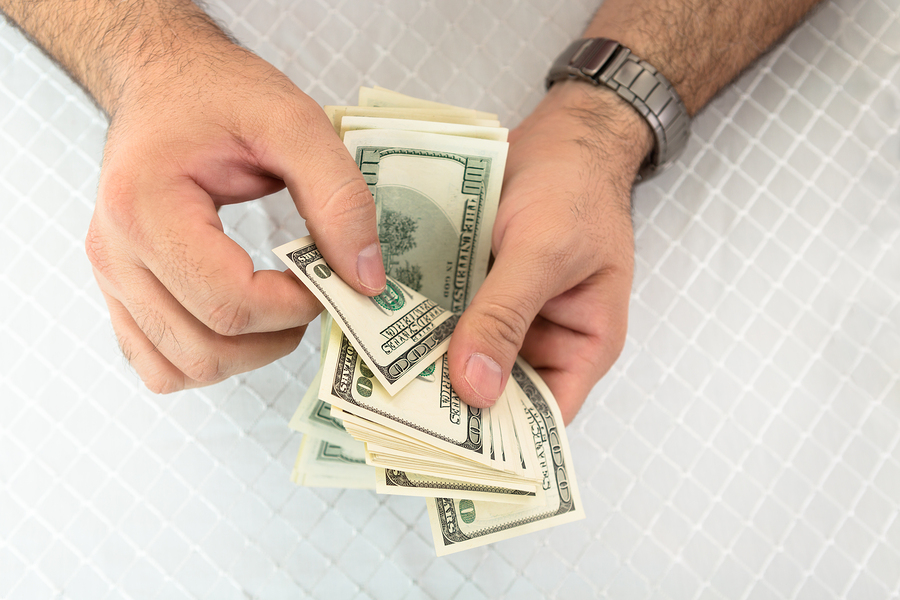 Man Counting Dollar Notes